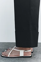 FLAT STRAPPY SANDALS WITH METAL ORNAMENT