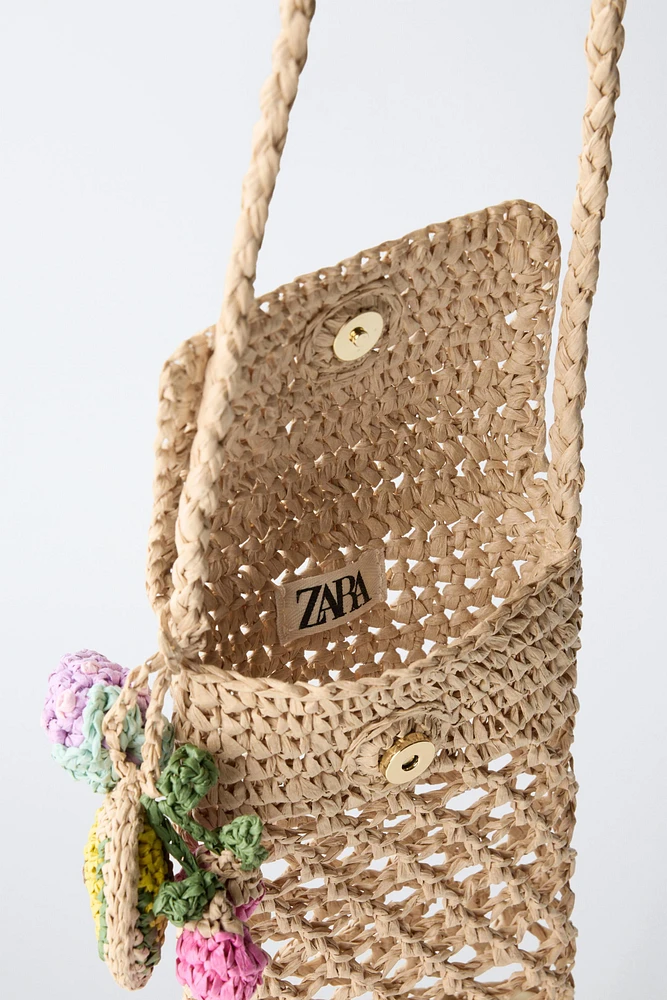 RAFFIA EFFECT PHONE CASE WITH CHARM