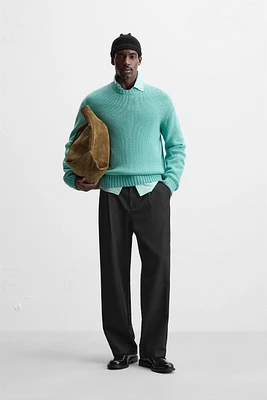 Relaxed fit cotton blend sweater. Round neck and long sleeves. Rib trim.