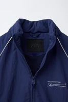 WATER REPELLENT TEXT PRINT HOODED RAINCOAT