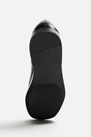 CHAUSSURES EN CUIR HABILLÉES