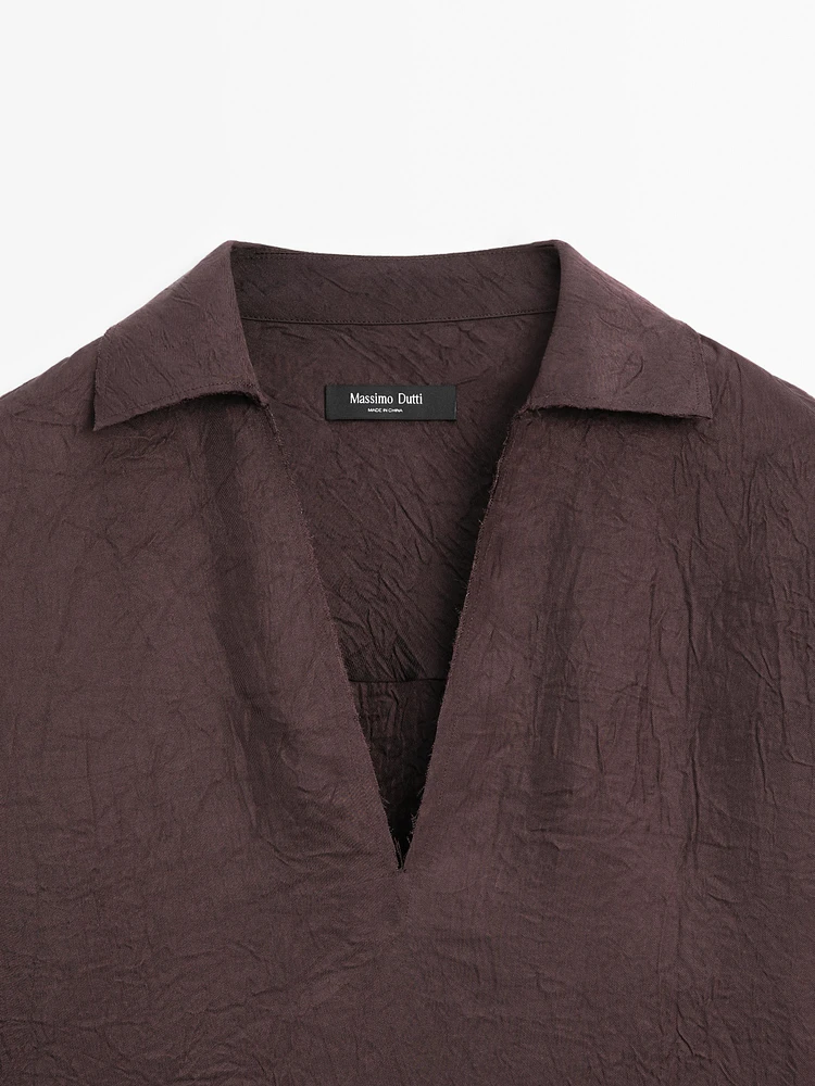 Flowing shirt featuring long sleeves with vents