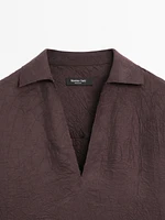 Flowing shirt featuring long sleeves with vents