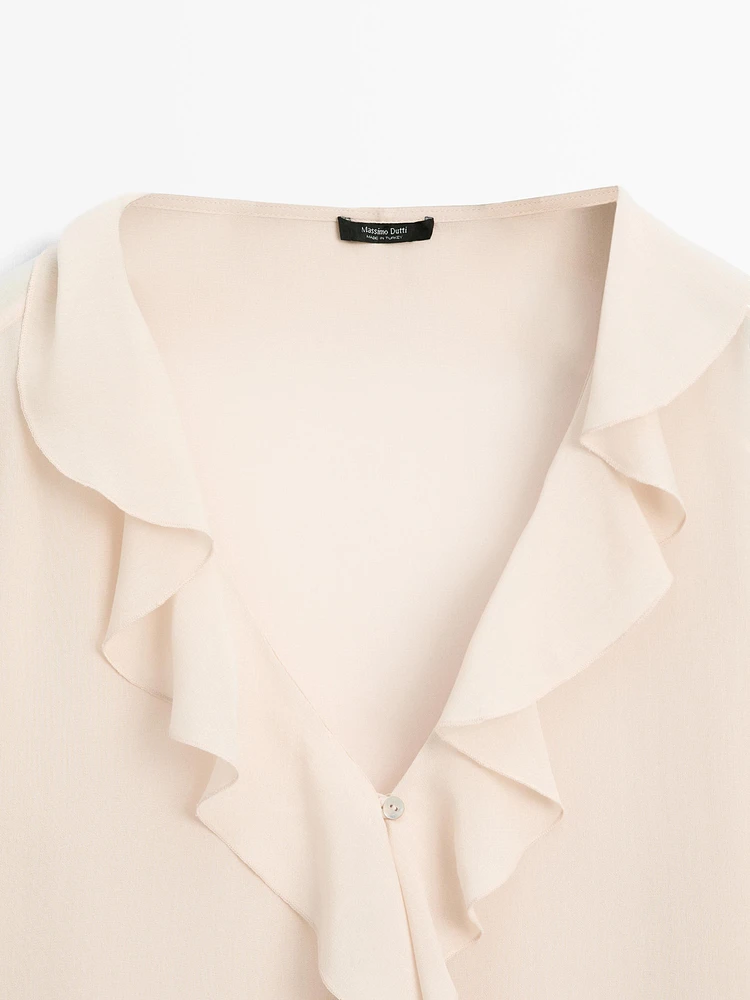 Ruffled blouse with asymmetric hem