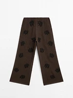 Flowing textured trousers with embroidered detail