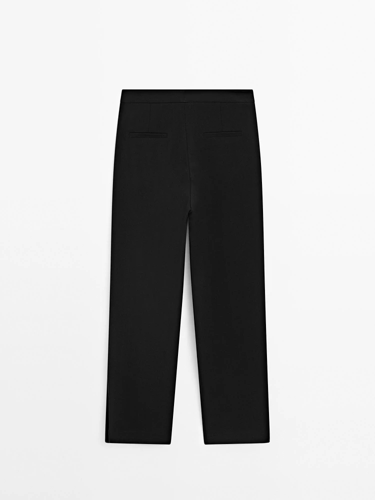 Trousers with buttoned hems