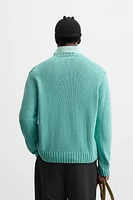 Relaxed fit cotton blend sweater. Round neck and long sleeves. Rib trim.