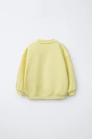 RAISED TEXT SWEATSHIRT