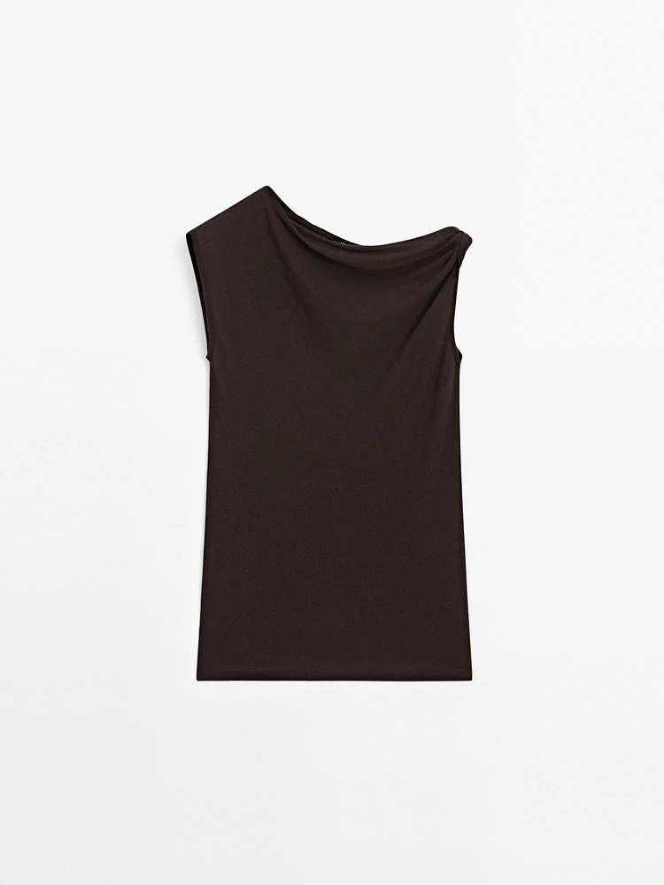 Top asymétrique avec nœud