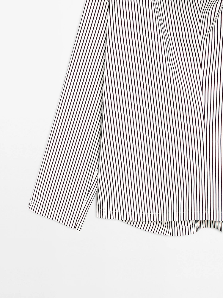Blouse with neckline drawstring and appliqué