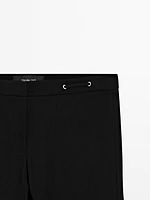 Flared trousers with waist detail