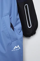 COMBINAISON À CAPUCHE DÉPERLANTE ET COUPE-VENT COLLECTION SKI