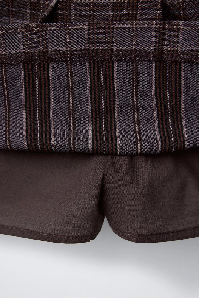 JUPE-SHORT À CARREAUX AVEC BOUCLES
