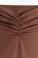 JUPE MI-LONGUE STRUCTURE À PLIS