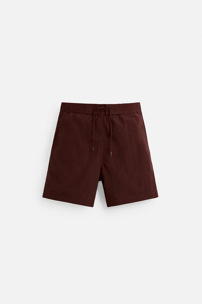DRAWSTRING SWIM TRUNKS
