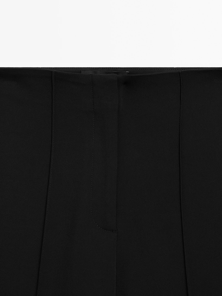 Flared trousers with zip
