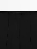 Flared trousers with zip