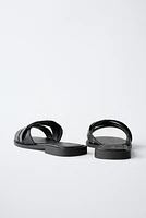 STUDDED CROSSOVER FLAT SANDALS