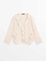 Ruffled blouse with asymmetric hem