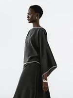 Cape blouse with batwing sleeves