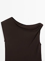 Top asymétrique avec nœud