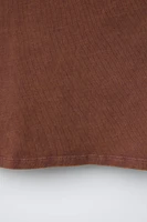 ASYMMETRIC EYELET TOP
