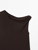 Top asymétrique avec nœud