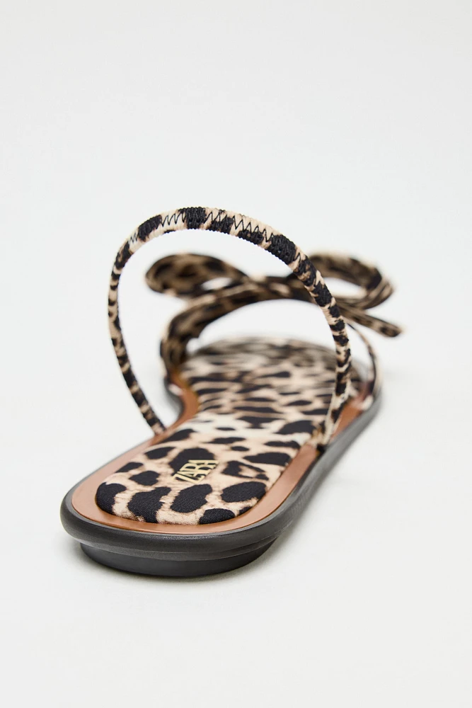ANIMAL PRINT BOW FLAT SANDALS