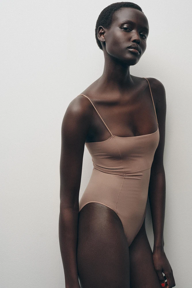 FITTED STRAPPY BODYSUIT WITH SEAMS