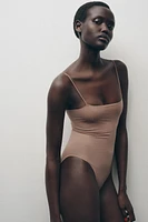 FITTED STRAPPY BODYSUIT WITH SEAMS