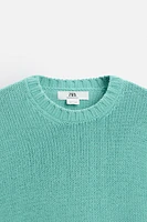 Relaxed fit cotton blend sweater. Round neck and long sleeves. Rib trim.