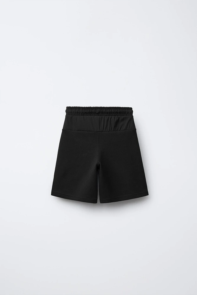 BERMUDA SPORT EN MATIÈRES VARIÉES
