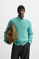 Relaxed fit cotton blend sweater. Round neck and long sleeves. Rib trim.