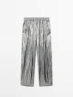 Flowing metallic trousers with gathered detail