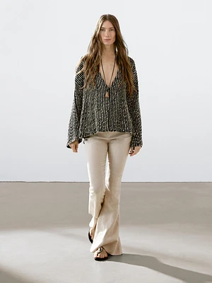 Pantalon flare taille contrastante