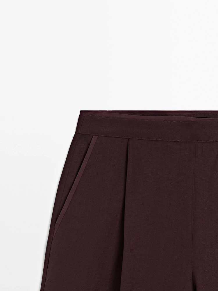 Flowing trousers with darts and thin waistband