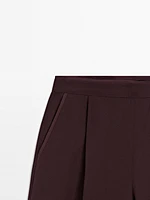 Flowing trousers with darts and thin waistband