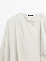 Short flowing cape with sleeve detail