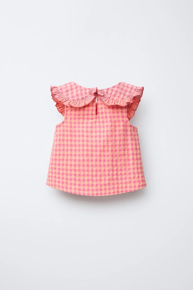 BLOUSE À CARREAUX ET BRODERIES