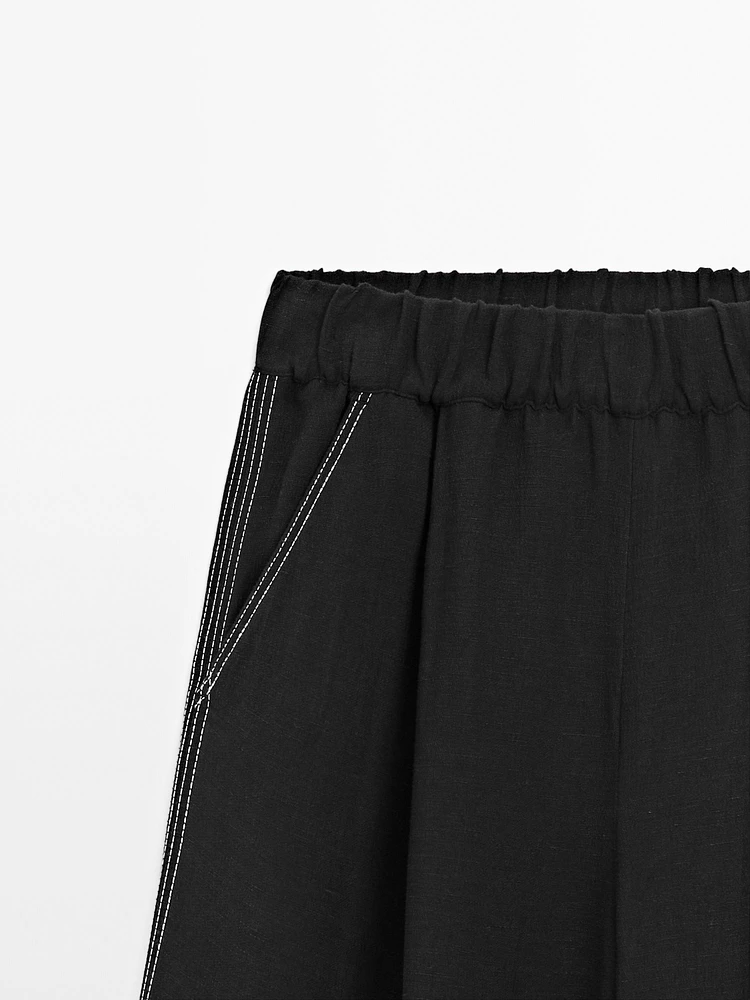 Flowing trousers with contrast topstitching