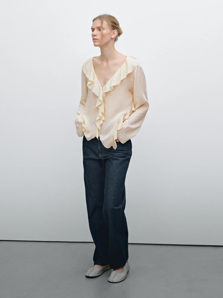 Ruffled blouse with asymmetric hem