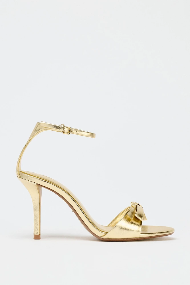 METALLIC EFFECT BOW HEELED SANDALS