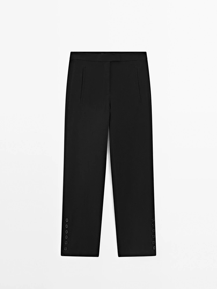 Trousers with buttoned hems
