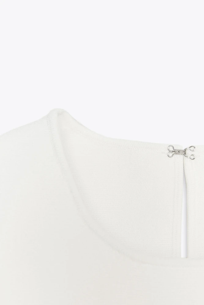 TOP EN MAILLE PÉPLUM AVEC LACETS