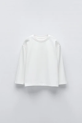 T-SHIRT UNI À ÉTIQUETTE