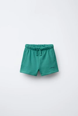 TEXT PLUSH SHORTS