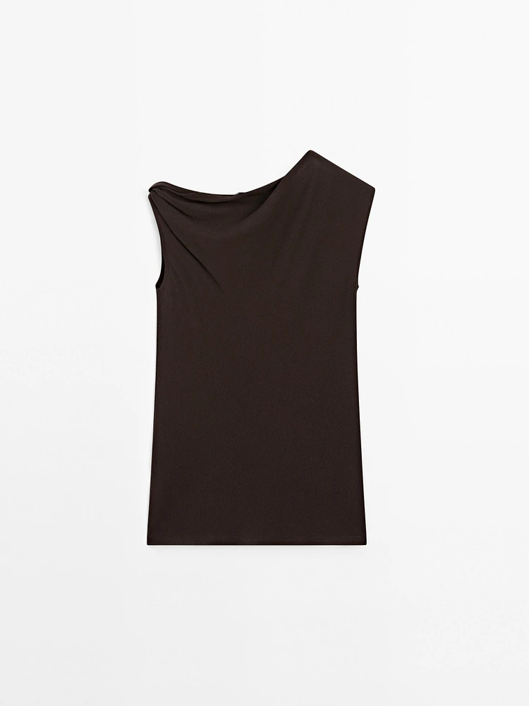 Top asymétrique avec nœud