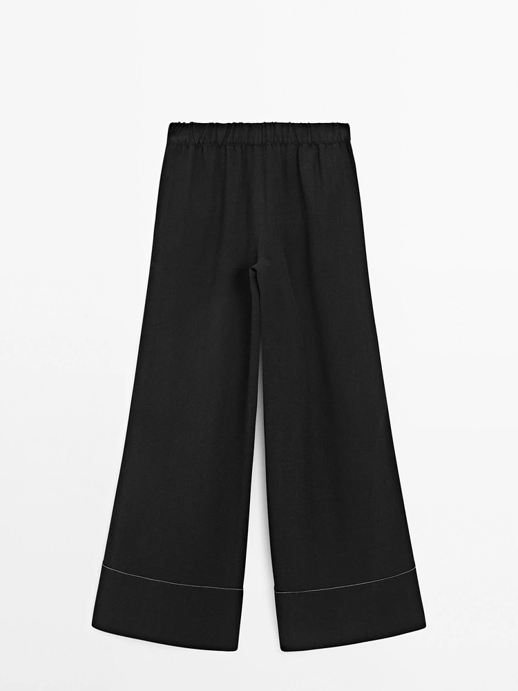 Flowing trousers with contrast topstitching