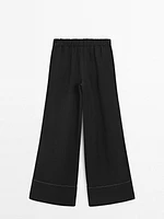 Flowing trousers with contrast topstitching