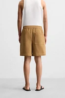 PLEATED FAUX SUEDE SHORTS